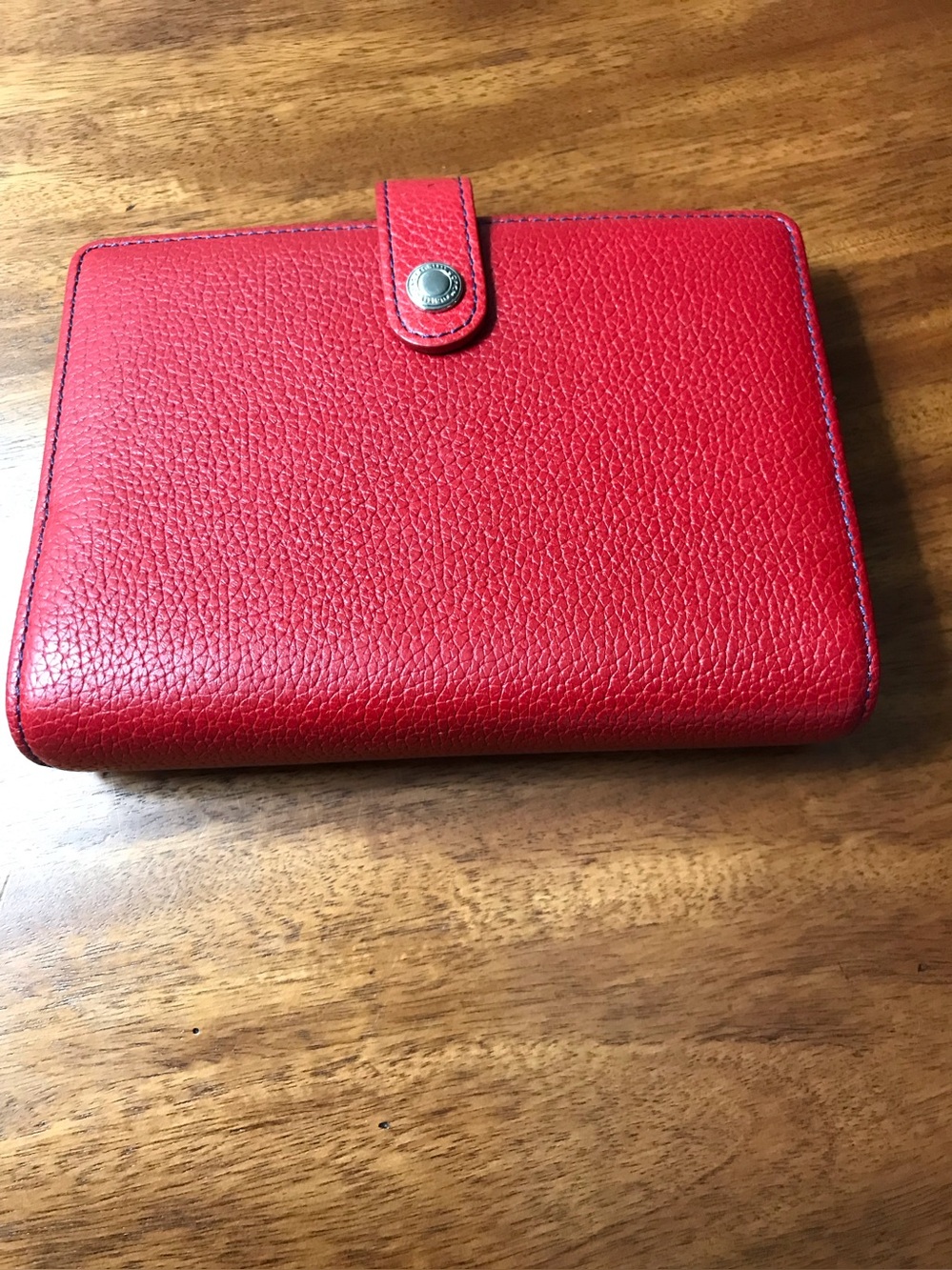 Coach mini leather ring organizer with snap closure.